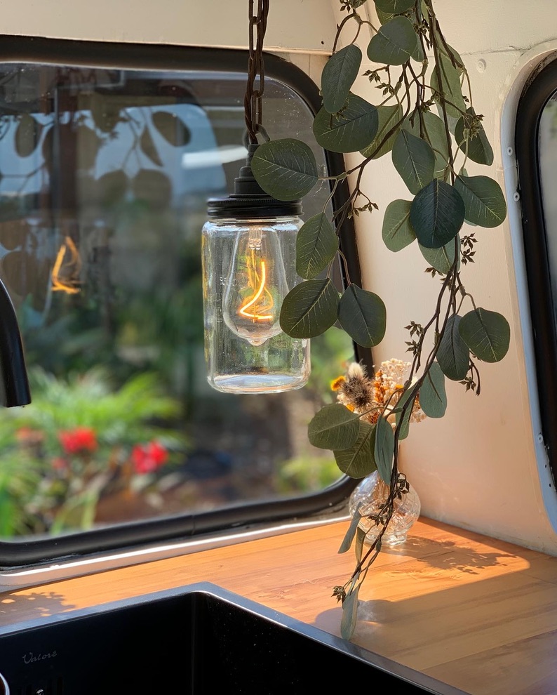 Hanging mason jar pendant light with eucalyptus styling