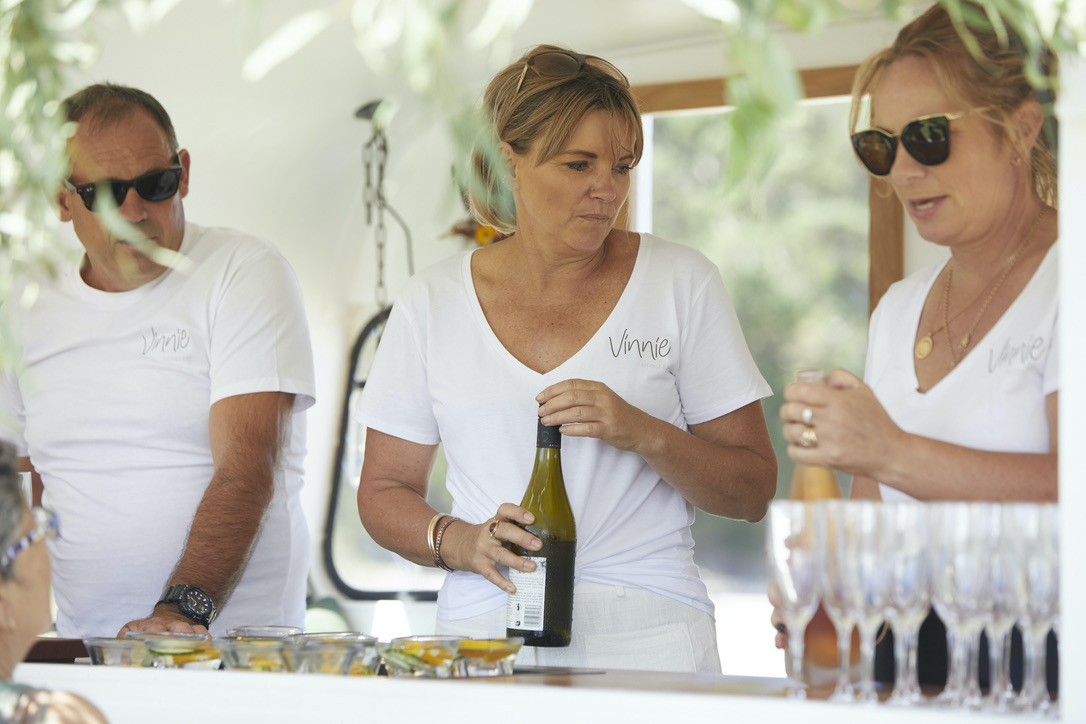 Vinnie's bar staff pouring wine for guests at an event